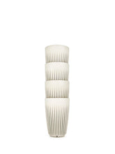 Decorative white stacked coffee cups with textured design on a white background