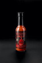 Hot sauce bottle labeled 'Wicked Smart Calypso' on a black background