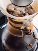 Chemex coffee maker with coffee being poured