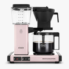 Pink Moccamaster coffee maker with a clear carafe on a white background