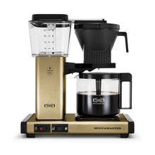 Moccamaster coffee maker with gold base and black components on a white background