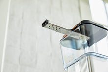 Espresso brewer head and arm on a white background