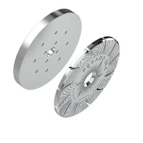 Two metallic disc components with intricate designs on a white background