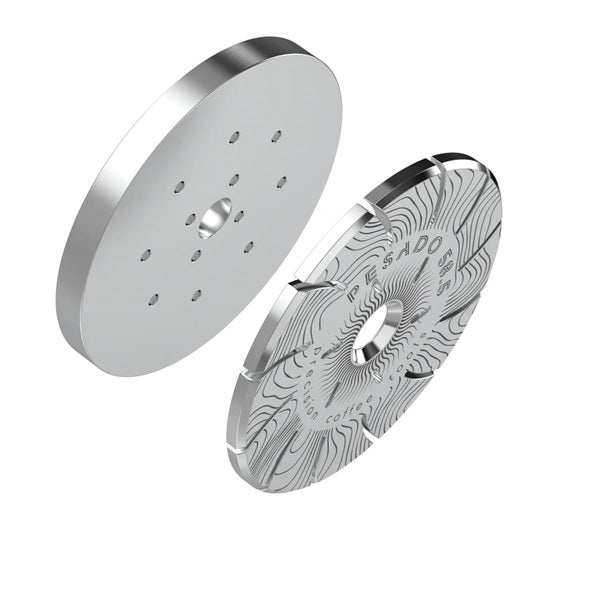 Two metallic disc components with intricate designs on a white background