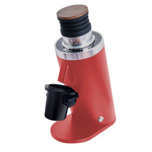 Red single dose coffee grinder with wooden top and black attachments on a white background