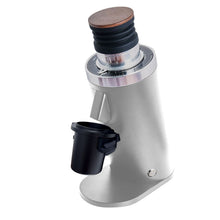 White coffee grinder with wooden top on a white background