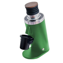 Green coffee grinder with wooden top on a white background