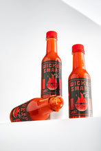 Three bottles of Wicked Smart hot sauce on a white background
