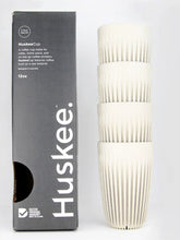 Huskee coffee cups with packaging on a white background