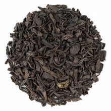 A close-up image of dry assam black tea leaves.