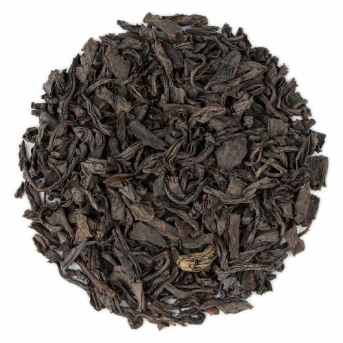 A close-up image of dry assam black tea leaves.