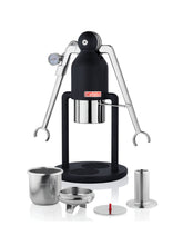 Black manual espresso machine with accessories on a white background
