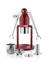 Red manual press with metal components on a white background