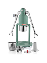 Green manual coffee press with accessories on a white background
