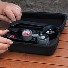 Black carrying case with a set of lenses on a wooden surface with Flair GO – The Ultimate Portable Lever Espresso Machine