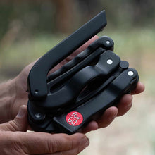 Flair GO – The Ultimate Portable Lever Espresso Machine Black multi-tool held in a hand with a blurred natural background