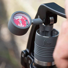 Pressure gauge attached to a coffee brewing device with 'flair' branding.