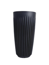 Black ribbed vase on a white background