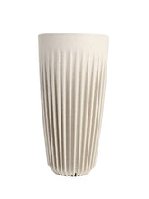 Beige textured vase on a white background