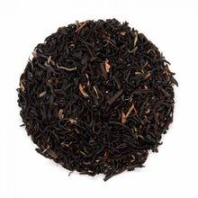 A close-up image of orange pekoe dried black tea leaves and buds.