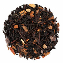 A close-up of Spicy Cacao loose leaf tea with visible pieces of black tea, cinnamon, ginger root, and chili flakes.