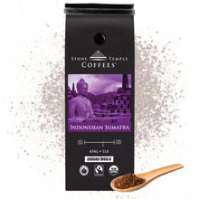 Stone Temple Coffees - Indonesian Sumatra Ground coffee bag on a background with coffee granules