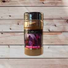 A jar of Stone Temple Coffees Tandoori Decaf Coffee Rub Seasoning with a label showing the product name and an image of spices. With wooden background.