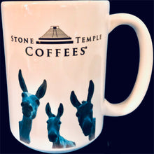 A white stoneware coffee mug with the Stone Temple Coffees logo and a blue illustration of a donkey on it.